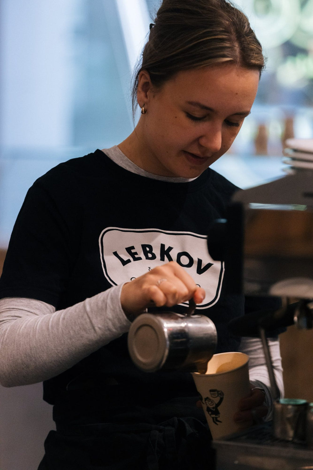 Lebkov barista pouring a latte